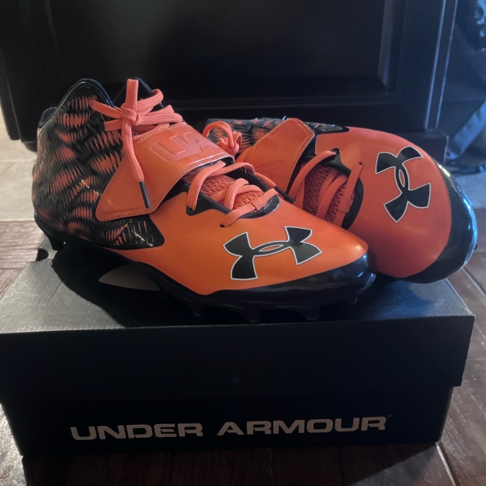 Under Armour Orange and Black football cleats for men.